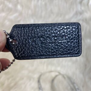 Black leather coach tag